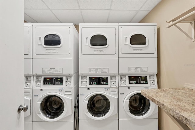 laundry area with stacked washer and clothes dryer and washing machine and clothes dryer