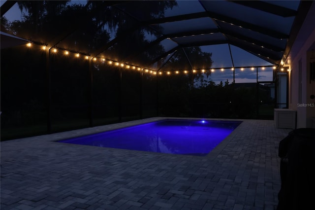 view of pool with a lanai and a patio