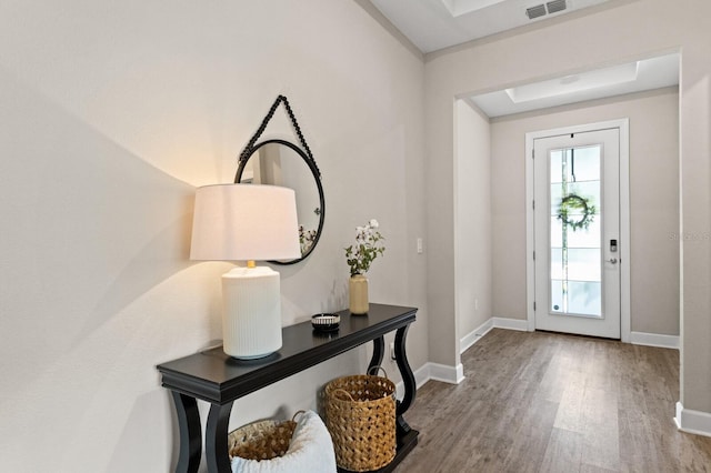 entryway featuring a raised ceiling and hardwood / wood-style floors