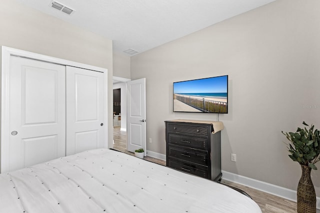 bedroom with a closet and light hardwood / wood-style flooring