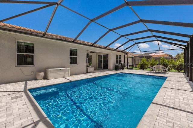 view of pool featuring a lanai, ceiling fan, and a patio area