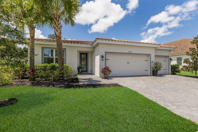 mediterranean / spanish-style house with a front yard and a garage