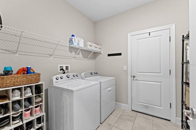 laundry area featuring light tile patterned floors and separate washer and dryer