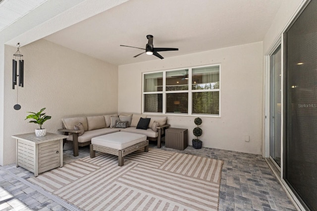 view of patio / terrace with ceiling fan and an outdoor living space