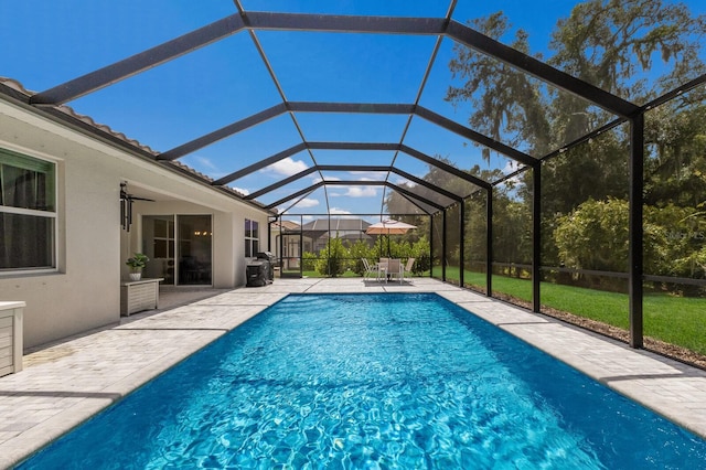 view of pool with a lanai, ceiling fan, and a patio area