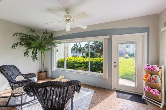 sunroom / solarium featuring ceiling fan