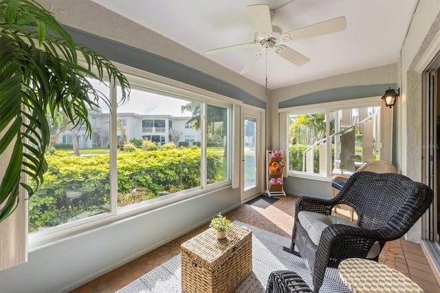 sunroom featuring plenty of natural light and ceiling fan