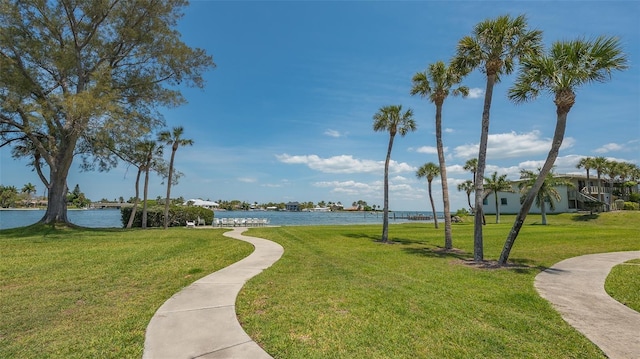 surrounding community with a yard and a water view