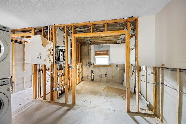 basement with stacked washer and clothes dryer