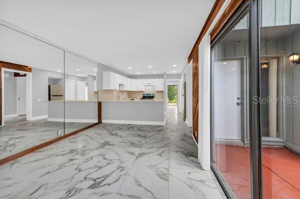1502 NE Buckeye Rd NE Unit 2, Winter Haven, FL 33881 - interior space featuring marble finish floor, baseboards, a sink, and recessed lighting