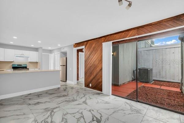 1502 NE Buckeye Rd NE Unit 2, Winter Haven, FL 33881 - unfurnished living room featuring recessed lighting, marble finish floor, wooden walls, and baseboards
