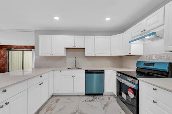 1502 NE Buckeye Rd NE Unit 2, Winter Haven, FL 33881 - kitchen with white cabinetry, stainless steel appliances, a sink, and light countertops