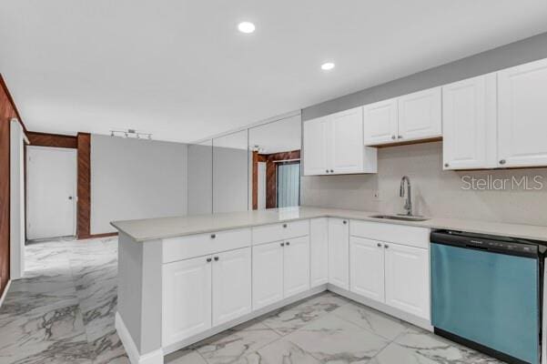 1502 NE Buckeye Rd NE Unit 2, Winter Haven, FL 33881 - kitchen with marble finish floor, light countertops, stainless steel dishwasher, a sink, and a peninsula