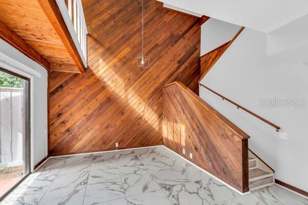 1502 NE Buckeye Rd NE Unit 2, Winter Haven, FL 33881 - additional living space with stairs, marble finish floor, and wooden walls