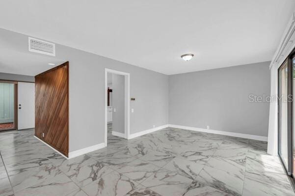 1502 NE Buckeye Rd NE Unit 2, Winter Haven, FL 33881 - empty room with marble finish floor, visible vents, and baseboards