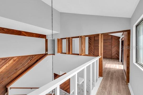 1502 NE Buckeye Rd NE Unit 2, Winter Haven, FL 33881 - hallway with vaulted ceiling, wood finished floors, and an upstairs landing