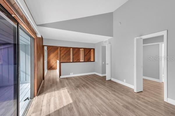 1502 NE Buckeye Rd NE Unit 2, Winter Haven, FL 33881 - interior space with light wood-style floors, baseboards, and high vaulted ceiling
