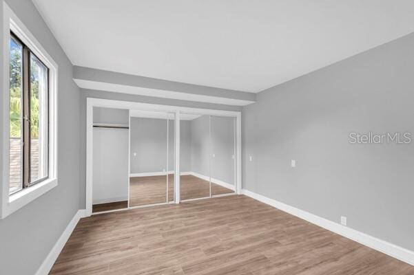 1502 NE Buckeye Rd NE Unit 2, Winter Haven, FL 33881 - unfurnished bedroom featuring wood finished floors and baseboards