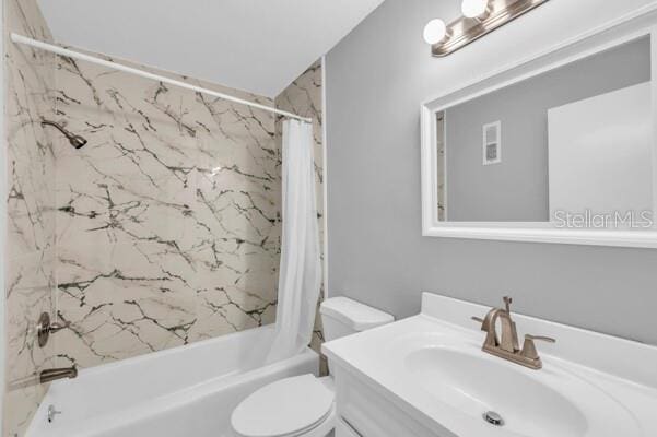 1502 NE Buckeye Rd NE Unit 2, Winter Haven, FL 33881 - bathroom with toilet, vanity, and shower / bathtub combination with curtain