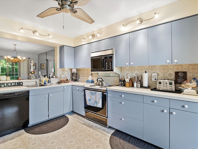 kitchen featuring backsplash, hanging light fixtures, ceiling fan with notable chandelier, sink, and black appliances