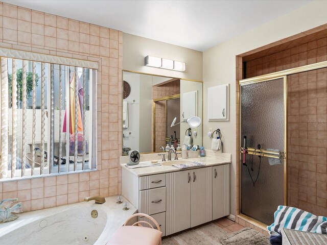 bathroom with separate shower and tub and vanity