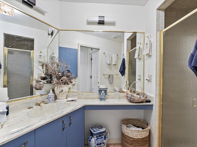 bathroom featuring vanity and a shower with shower door