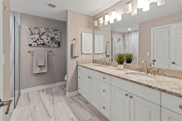 bathroom featuring vanity, an enclosed shower, and toilet