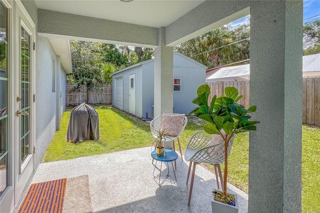 view of patio with an outbuilding