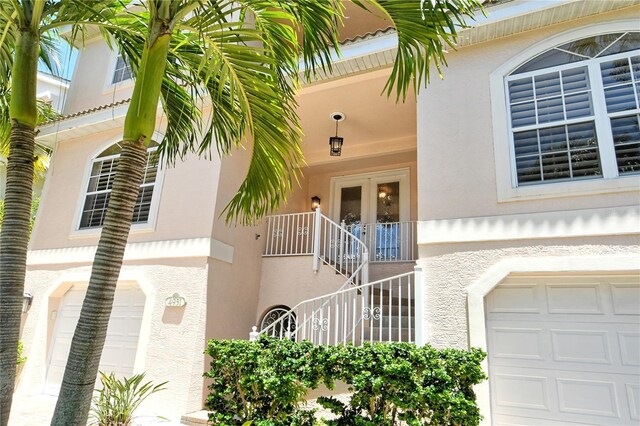 doorway to property featuring french doors and a garage