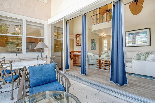 exterior space featuring ceiling fan and light wood-type flooring