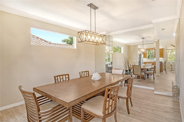 dining room featuring light hardwood / wood-style flooring, ornamental molding, and a chandelier