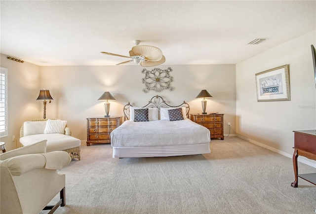 bedroom with ceiling fan and light carpet