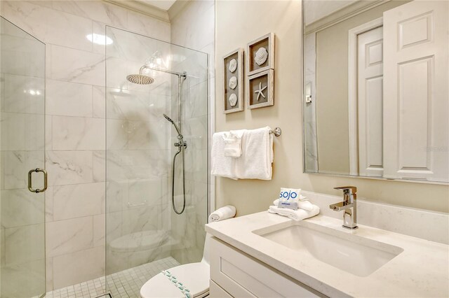 bathroom featuring toilet, vanity, and walk in shower