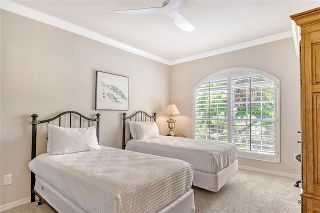 carpeted bedroom with ceiling fan and ornamental molding