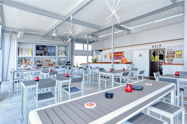 interior space featuring ceiling fan and beamed ceiling