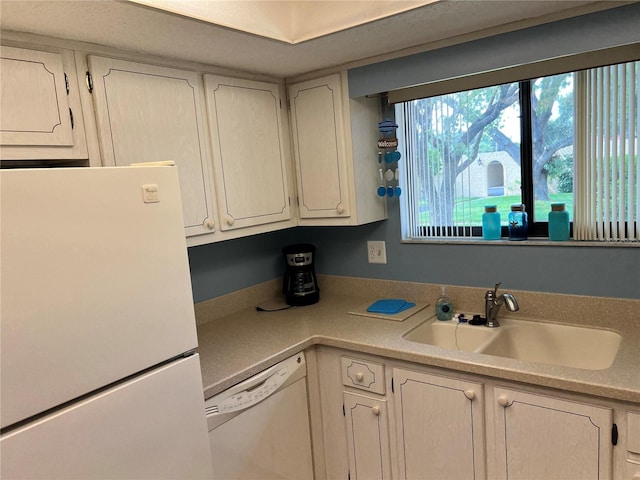 kitchen with sink and white appliances