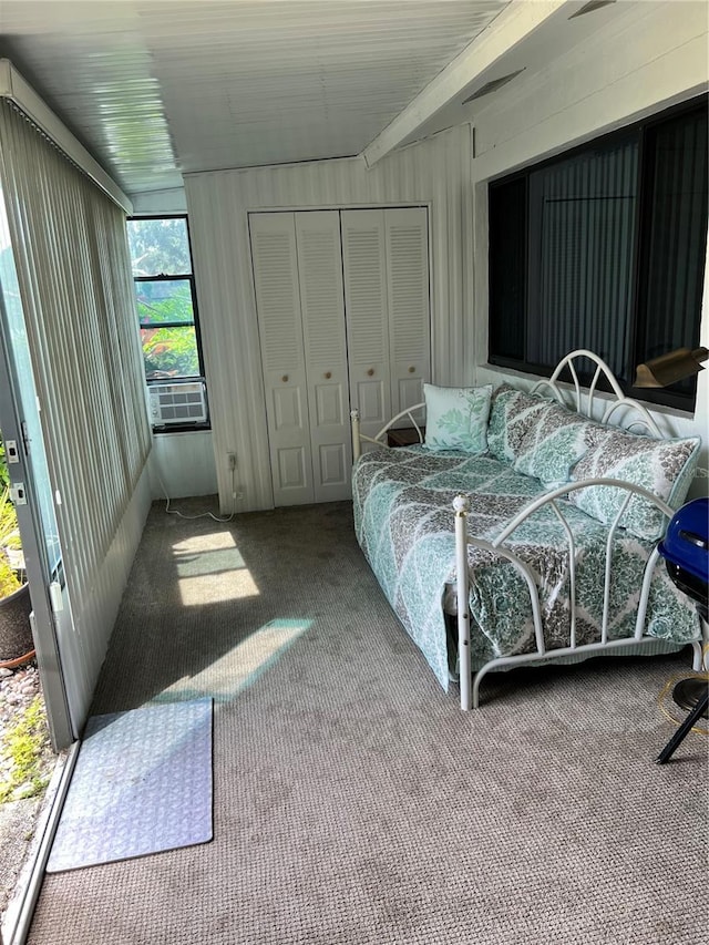 carpeted bedroom featuring a closet and cooling unit