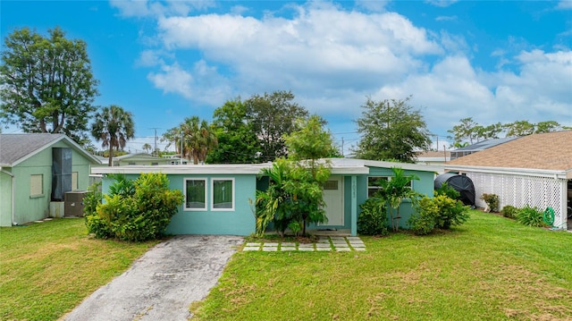 ranch-style home with a front lawn