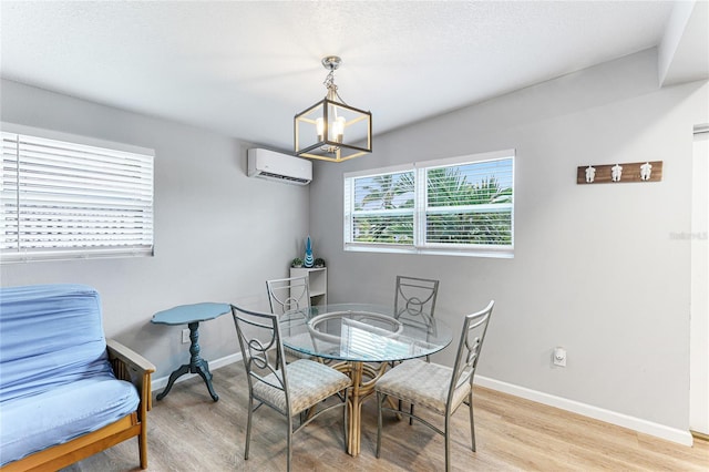 dining area featuring light wood-type flooring, baseboards, and a wall mounted AC