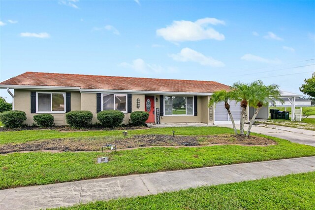 ranch-style home with a front lawn and a garage