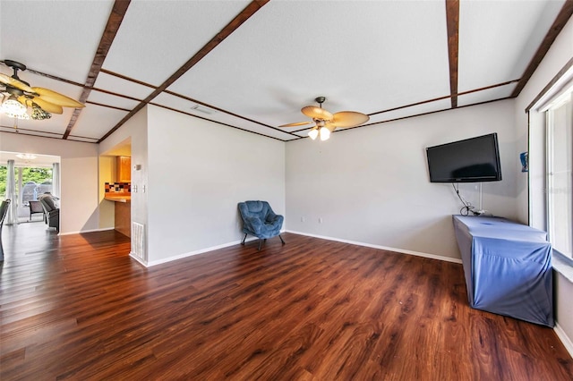 unfurnished living room featuring ceiling fan and dark hardwood / wood-style floors