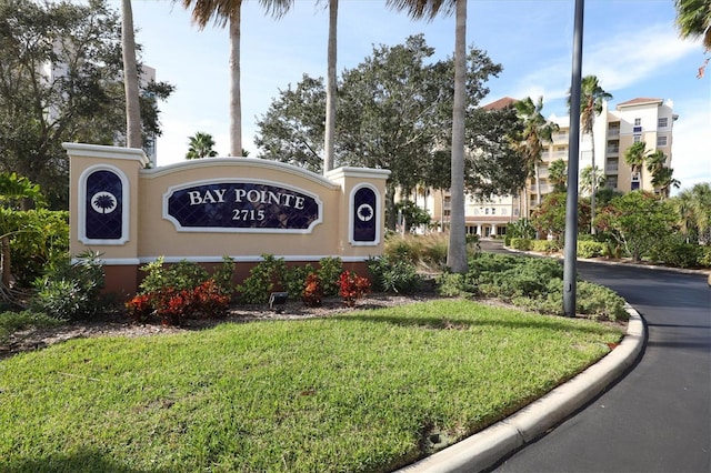 community sign featuring a lawn