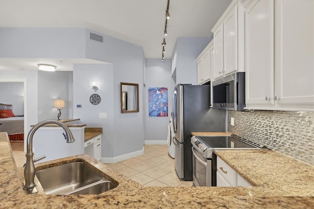 kitchen featuring visible vents, white cabinetry, stainless steel appliances, and a sink