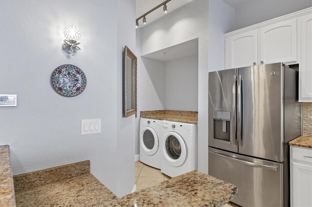 laundry room featuring laundry area, light tile patterned flooring, rail lighting, and washer and dryer