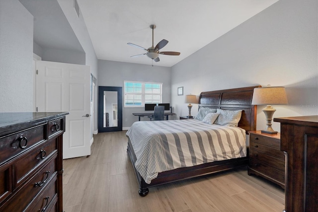 bedroom featuring vaulted ceiling, ceiling fan, baseboards, and light wood-style floors