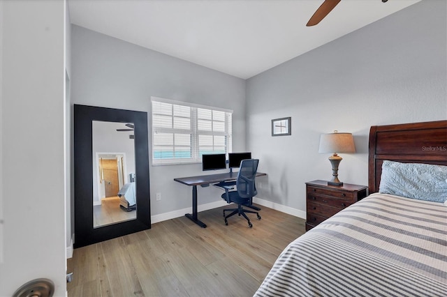 bedroom with light wood-style floors, baseboards, and a ceiling fan