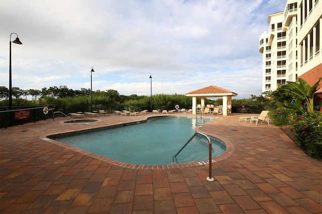 pool with a patio, a gazebo, and fence