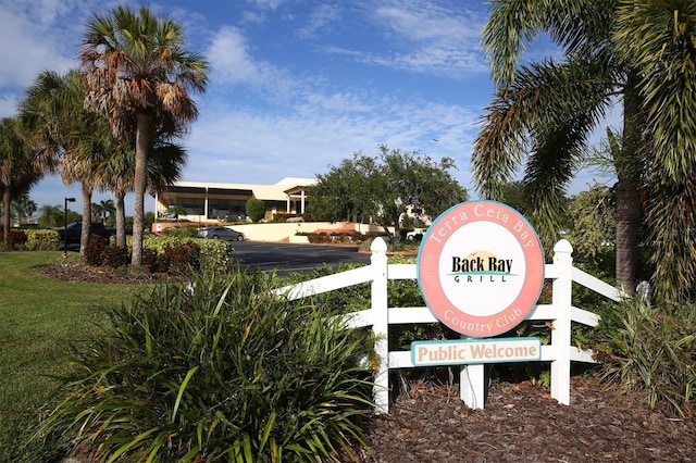 community / neighborhood sign with a lawn