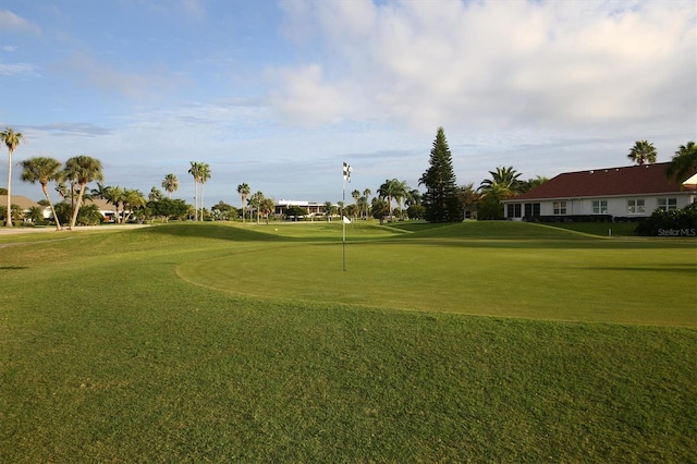 surrounding community with view of golf course