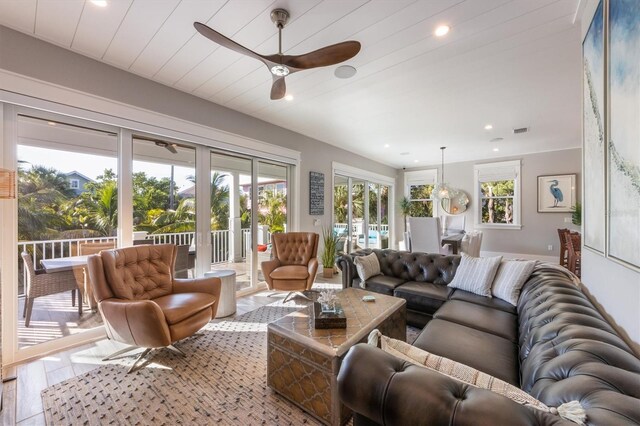 living room featuring ceiling fan and hardwood / wood-style flooring